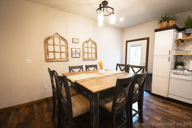 dining space with baseboards and dark wood-style flooring