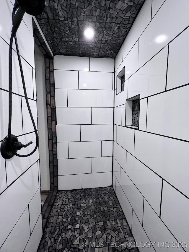 bathroom with tiled shower