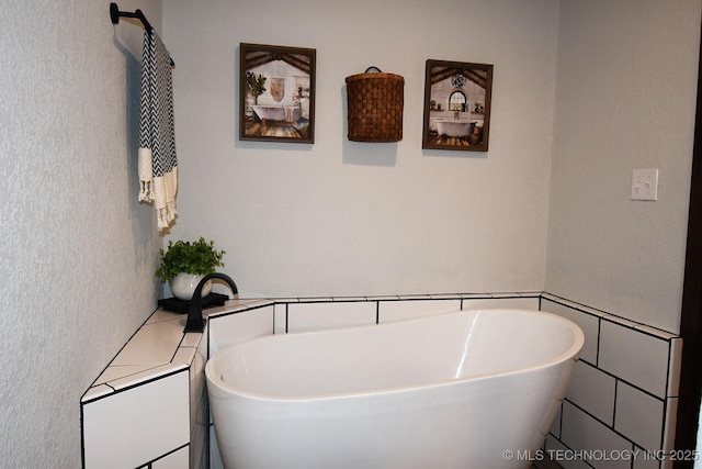 full bath featuring a freestanding bath