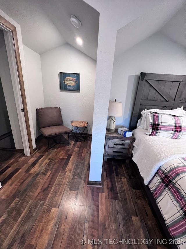 bedroom featuring vaulted ceiling and wood finished floors