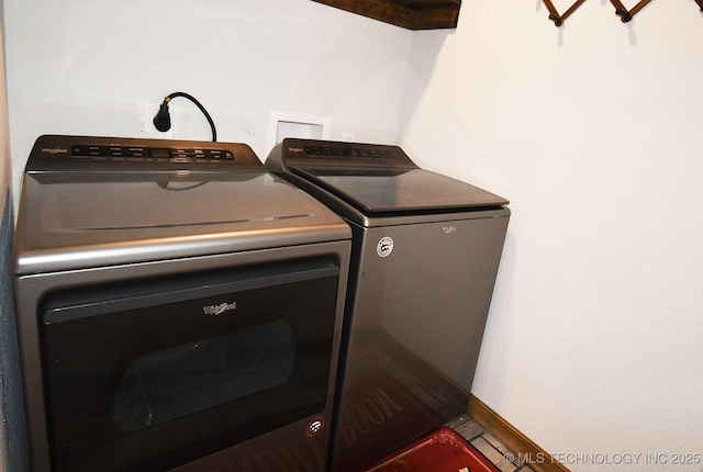 laundry room with washing machine and clothes dryer