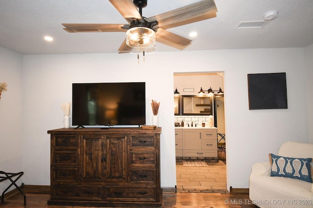 living area featuring a ceiling fan, recessed lighting, visible vents, and wood finished floors