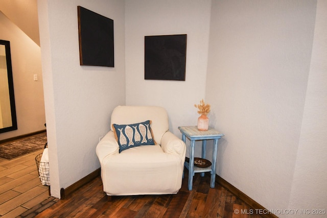 living area with baseboards and wood finished floors