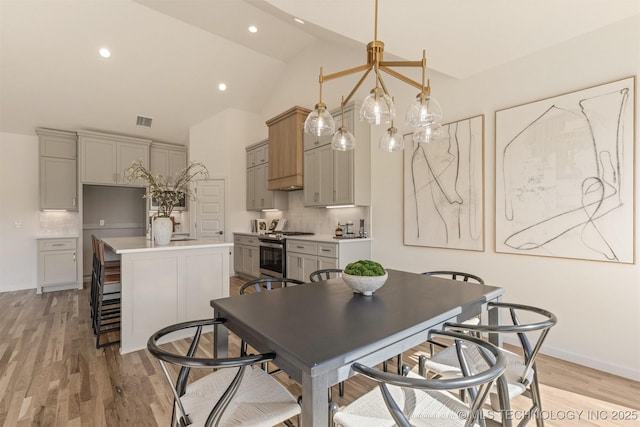 dining space featuring baseboards, visible vents, light wood-type flooring, high vaulted ceiling, and recessed lighting