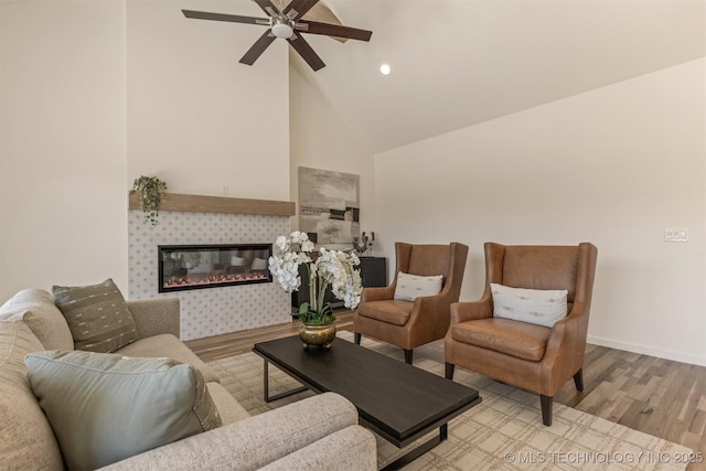 living room featuring recessed lighting, a tiled fireplace, high vaulted ceiling, light wood-type flooring, and baseboards