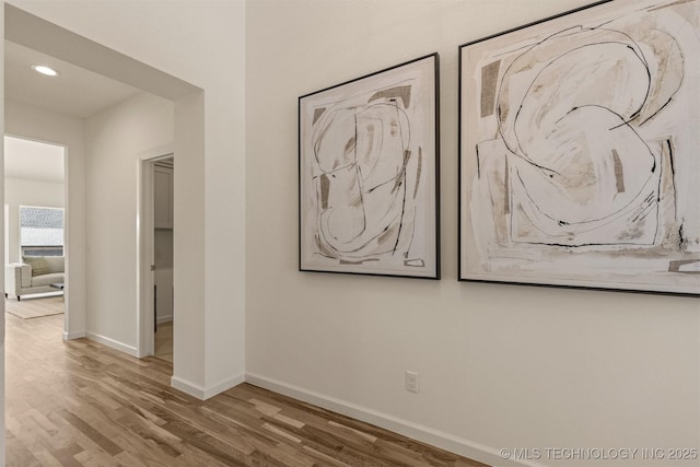 interior space with recessed lighting, baseboards, and wood finished floors