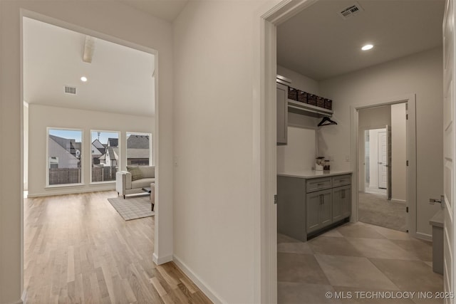 hallway featuring recessed lighting, visible vents, and baseboards