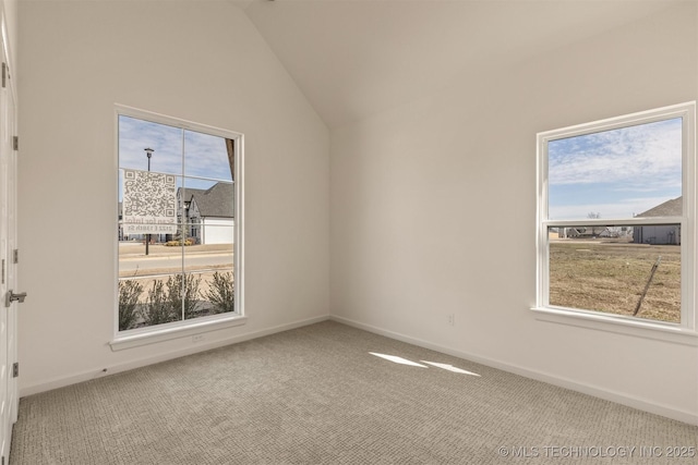 unfurnished room featuring lofted ceiling, carpet flooring, and baseboards