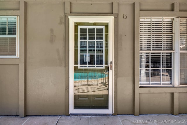 doorway to property with stucco siding