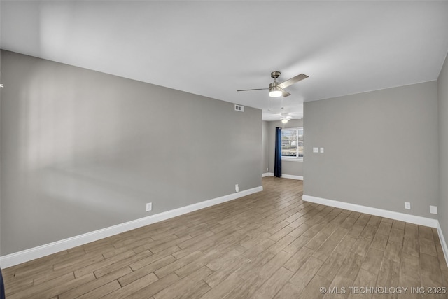 unfurnished room featuring visible vents, ceiling fan, baseboards, and wood finished floors