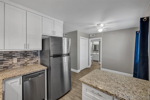 kitchen featuring tasteful backsplash, visible vents, appliances with stainless steel finishes, light wood-style floors, and white cabinets