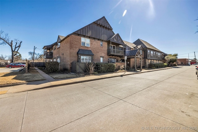 view of front of property with brick siding and board and batten siding