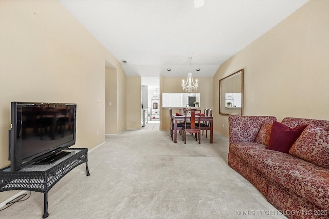 living room with light colored carpet, vaulted ceiling, baseboards, and an inviting chandelier