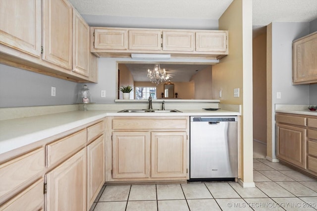 kitchen featuring light tile patterned floors, light countertops, stainless steel dishwasher, light brown cabinets, and a sink