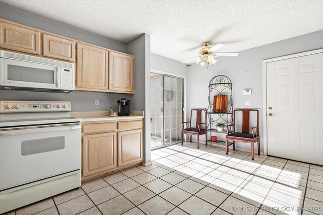 kitchen with light tile patterned floors, white appliances, a ceiling fan, light countertops, and light brown cabinetry