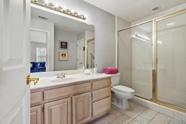 bathroom featuring a stall shower, visible vents, tile patterned flooring, a textured ceiling, and vanity