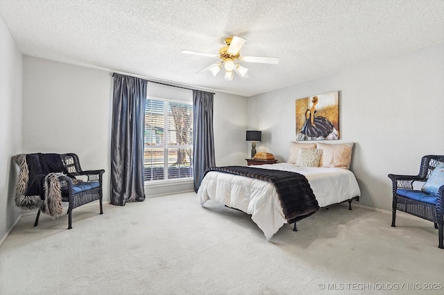 bedroom featuring a textured ceiling, carpet, and a ceiling fan