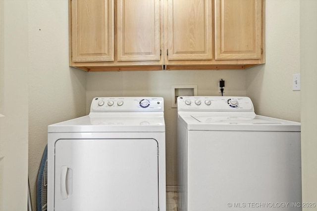 laundry room featuring cabinet space and separate washer and dryer