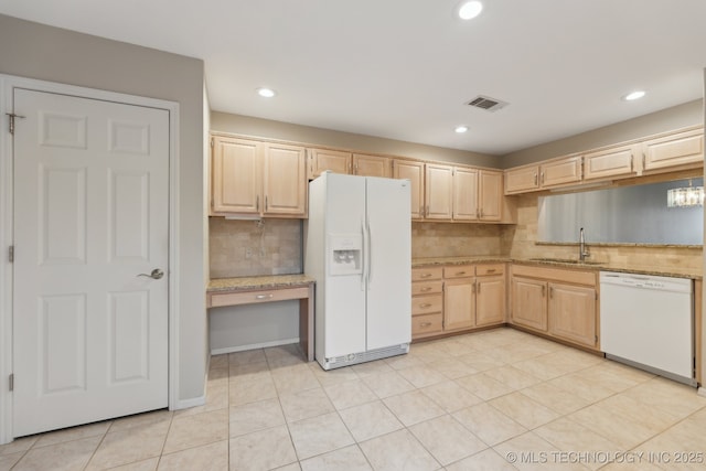 kitchen featuring white appliances, visible vents, built in study area, light brown cabinets, and a sink