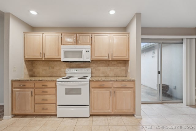 kitchen with white appliances and light brown cabinetry