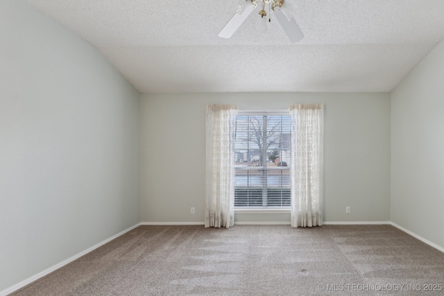 empty room featuring carpet, baseboards, ceiling fan, and a textured ceiling