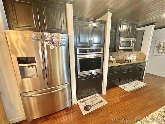 kitchen with wooden ceiling, dark wood-style flooring, appliances with stainless steel finishes, backsplash, and light stone countertops