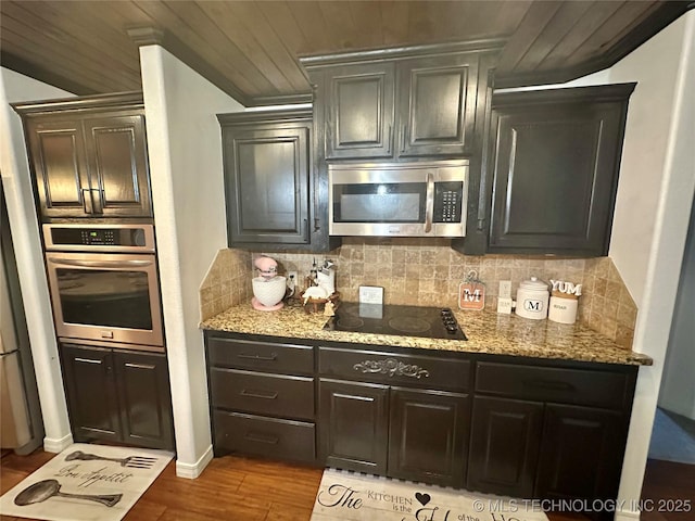 kitchen featuring light stone countertops, tasteful backsplash, and stainless steel appliances