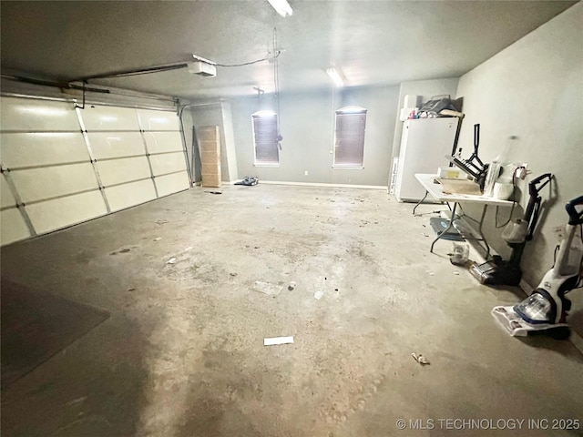 garage featuring a garage door opener and fridge