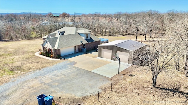 birds eye view of property featuring a wooded view