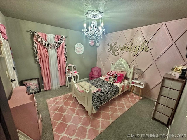 bedroom with a chandelier, a textured ceiling, carpet, and baseboards