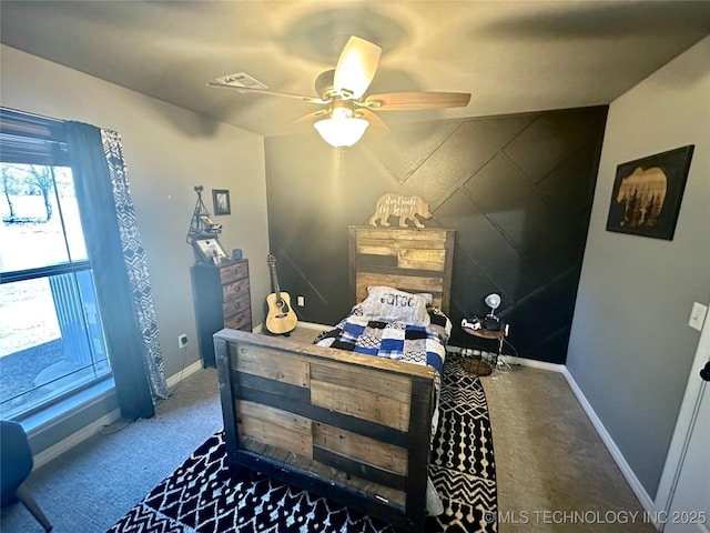 bedroom with a ceiling fan, visible vents, baseboards, and carpet flooring