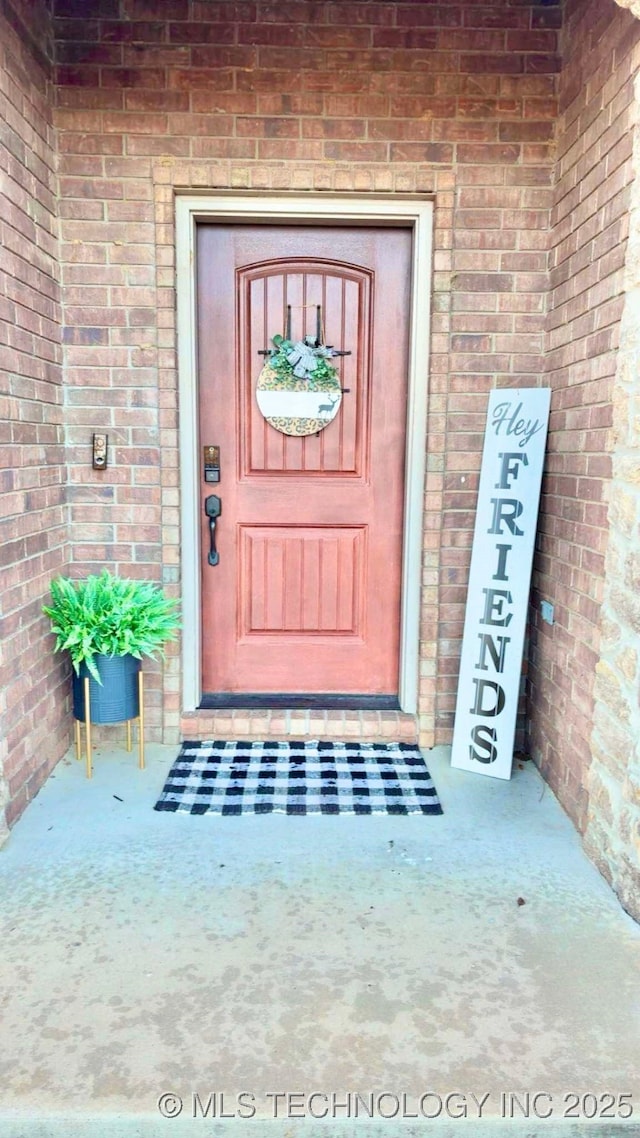 entrance to property with brick siding