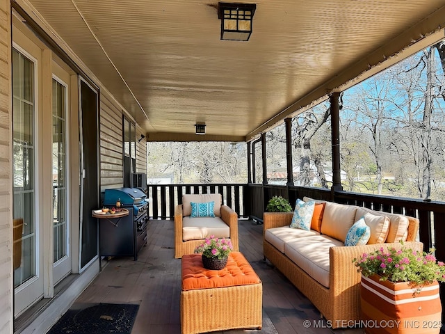 sunroom / solarium featuring wooden ceiling