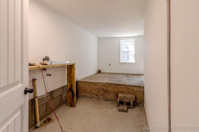 empty room with ornamental molding and a sink