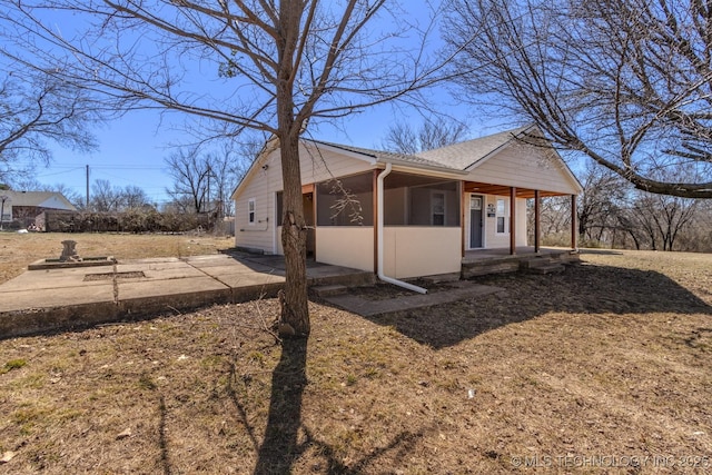 view of side of home with a patio area