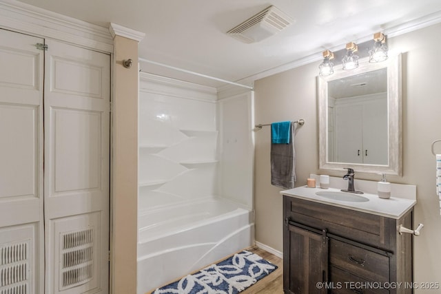 bathroom with visible vents, shower / bathing tub combination, vanity, and wood finished floors