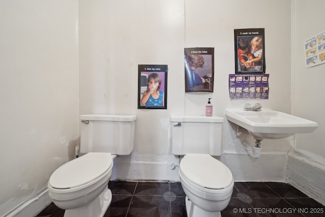 bathroom with toilet and tile patterned floors