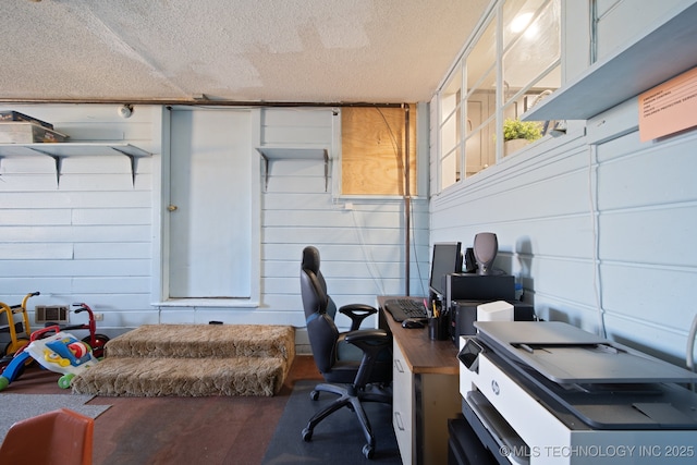 home office with a textured ceiling and wood finished floors