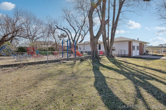 view of yard with fence and playground community