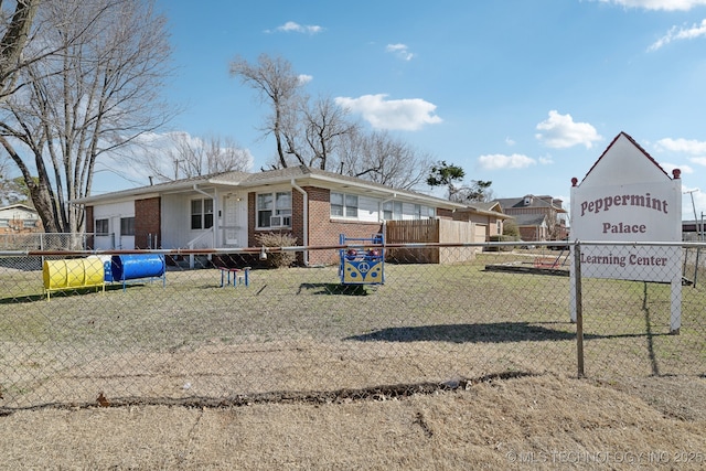 exterior space with fence, a front lawn, and brick siding