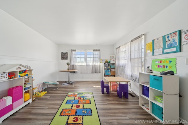 playroom with baseboards and wood finished floors