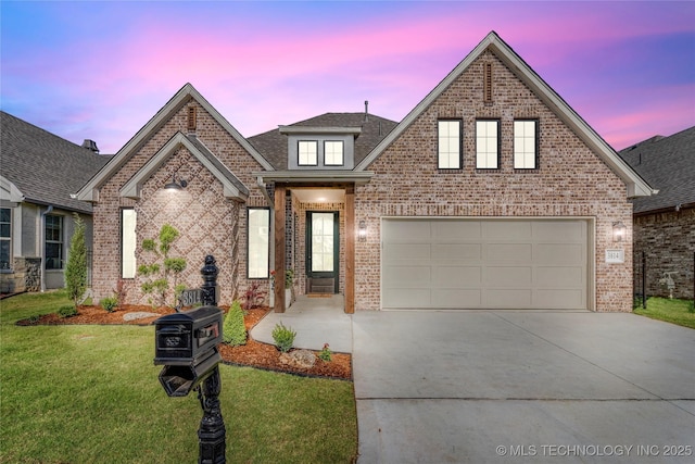 traditional-style home with concrete driveway, brick siding, a lawn, and an attached garage