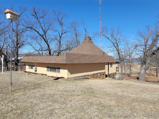 view of side of home featuring a shingled roof