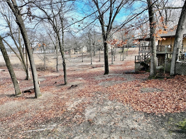 view of yard with stairway and a deck