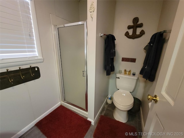 full bathroom with a stall shower, tile patterned flooring, toilet, and baseboards