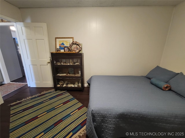 bedroom with dark wood finished floors