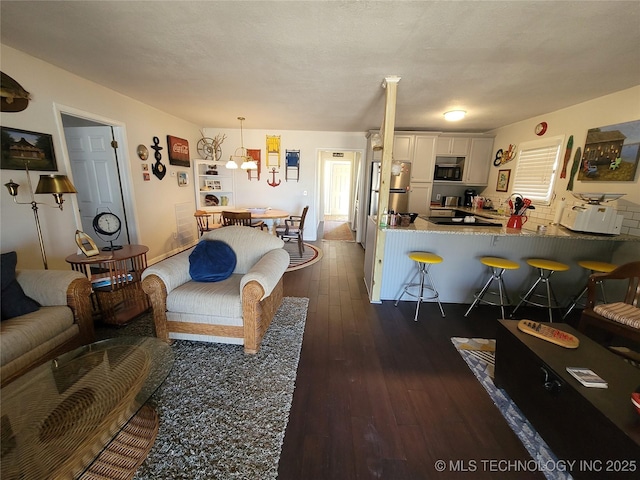 living room with dark wood finished floors and a textured ceiling