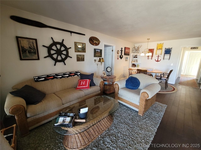 living area featuring a chandelier and wood finished floors