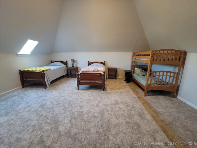 carpeted bedroom featuring vaulted ceiling and baseboards