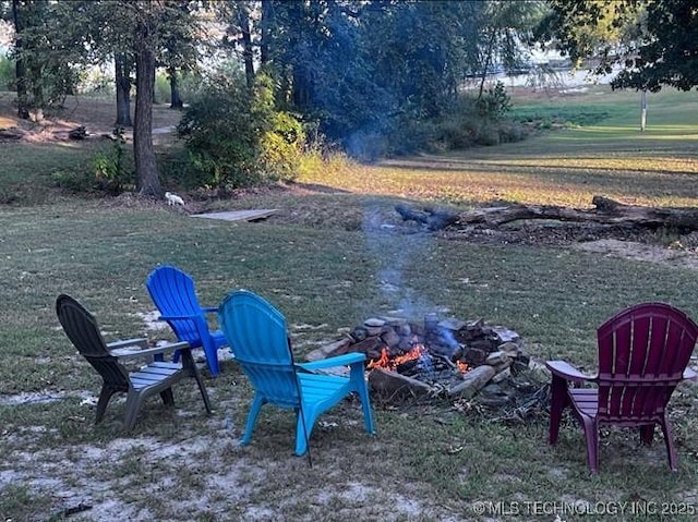 view of yard featuring an outdoor fire pit